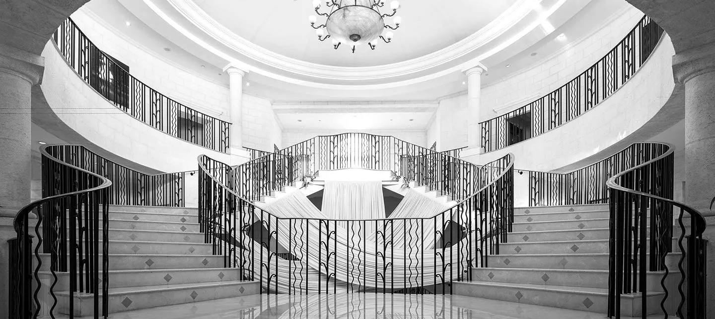 Twin curved staircases in a domed lobby