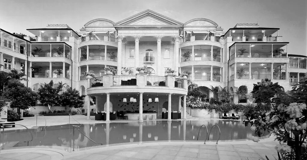 Balconied resort building beside a swimming pool
